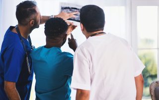 doctor and nurses looking at xray