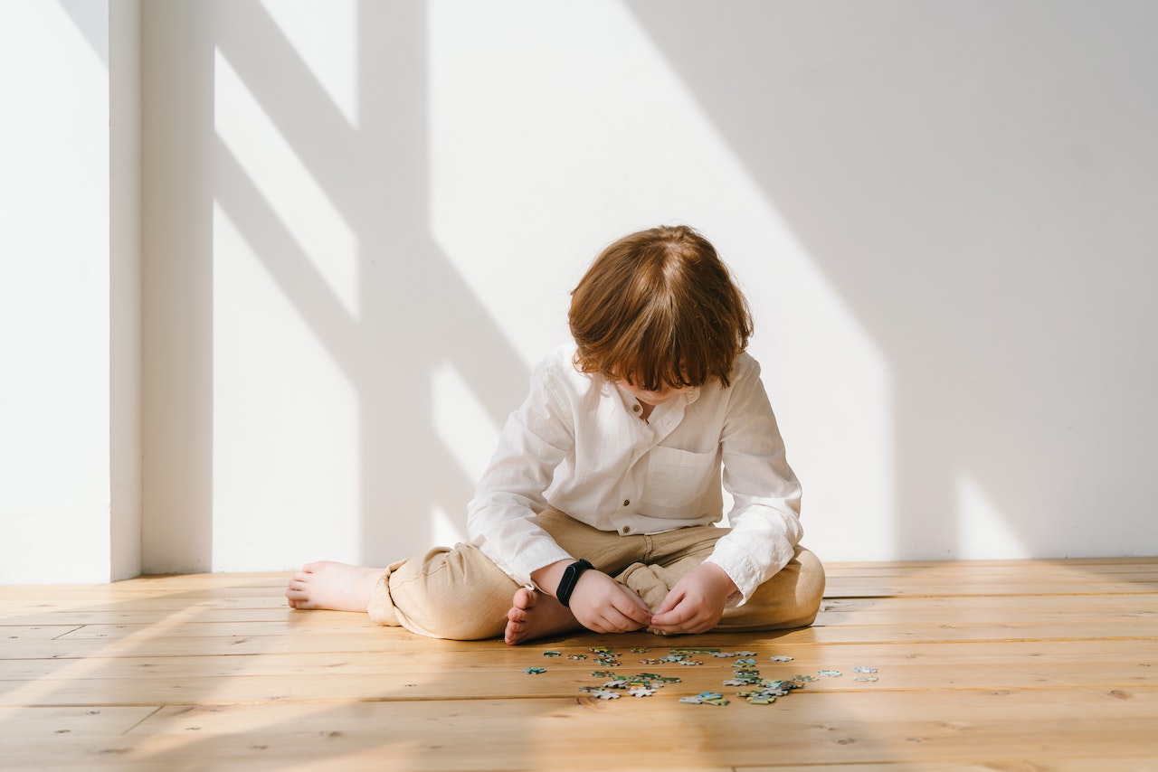 child building a puzzle