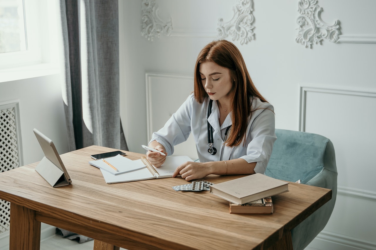 doctor writing on paper