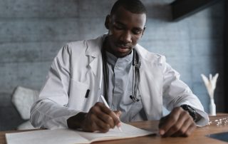 doctor writing on paper