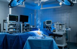 A contained flame burns beside sterile drapes in a modern operating room.
