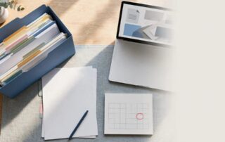 Organized SSDI appeal papers, medical folder, pen, calendar, and laptop on a desk.